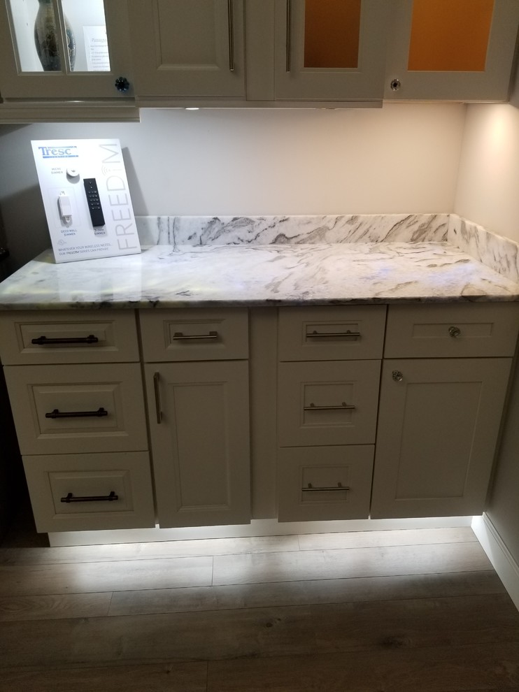 Eclectic laminate floor kitchen photo with shaker cabinets, white cabinets and quartzite countertops
