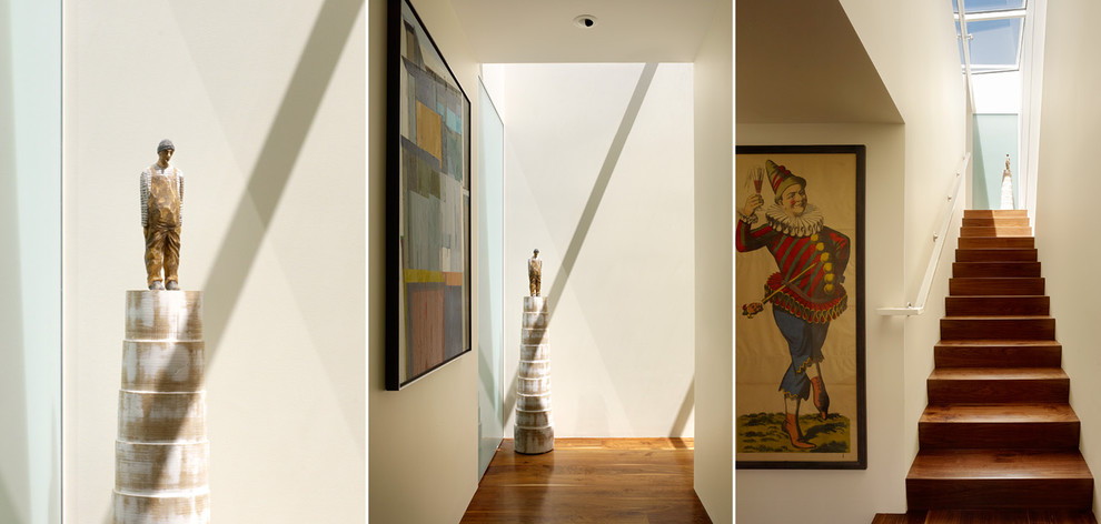 Design ideas for a mid-sized modern hallway in San Francisco with white walls and medium hardwood floors.