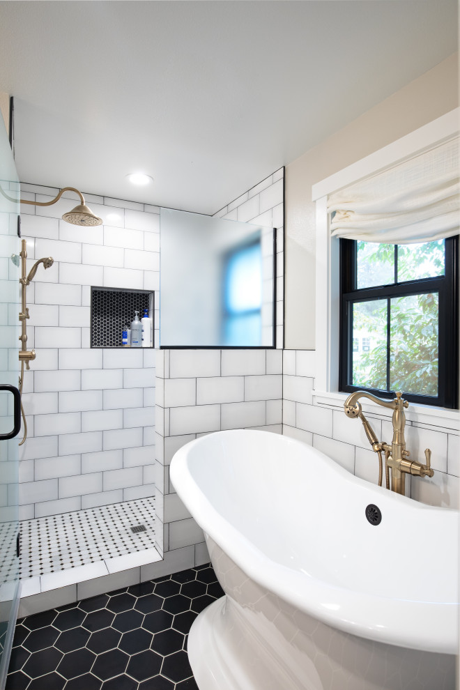 Example of a large country master white tile black floor freestanding bathtub design in Seattle with beige walls and a hinged shower door