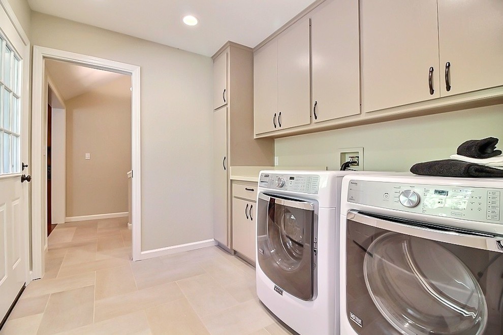 Photo of a mid-sized transitional single-wall dedicated laundry room in San Francisco with flat-panel cabinets, beige cabinets, quartz benchtops, beige walls, porcelain floors and a side-by-side washer and dryer.