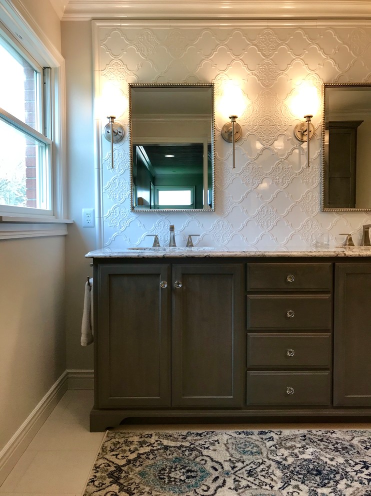 Mid-sized transitional master white tile and ceramic tile ceramic tile walk-in shower photo with recessed-panel cabinets, an undermount sink, quartz countertops, a hinged shower door, multicolored countertops and gray cabinets