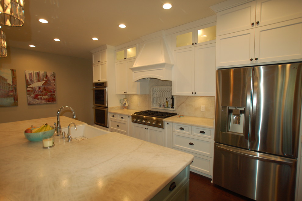 Large transitional medium tone wood floor and brown floor eat-in kitchen photo in San Diego with a farmhouse sink, shaker cabinets, white cabinets, quartzite countertops, beige backsplash, stainless steel appliances and an island
