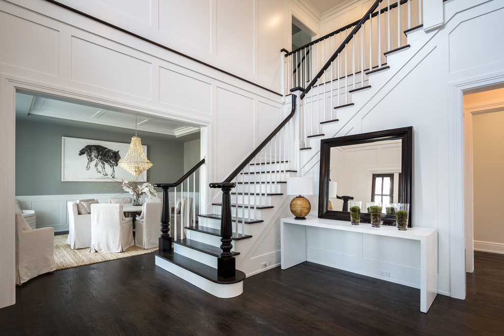 Mid-sized transitional foyer in New York with white walls, dark hardwood floors and brown floor.