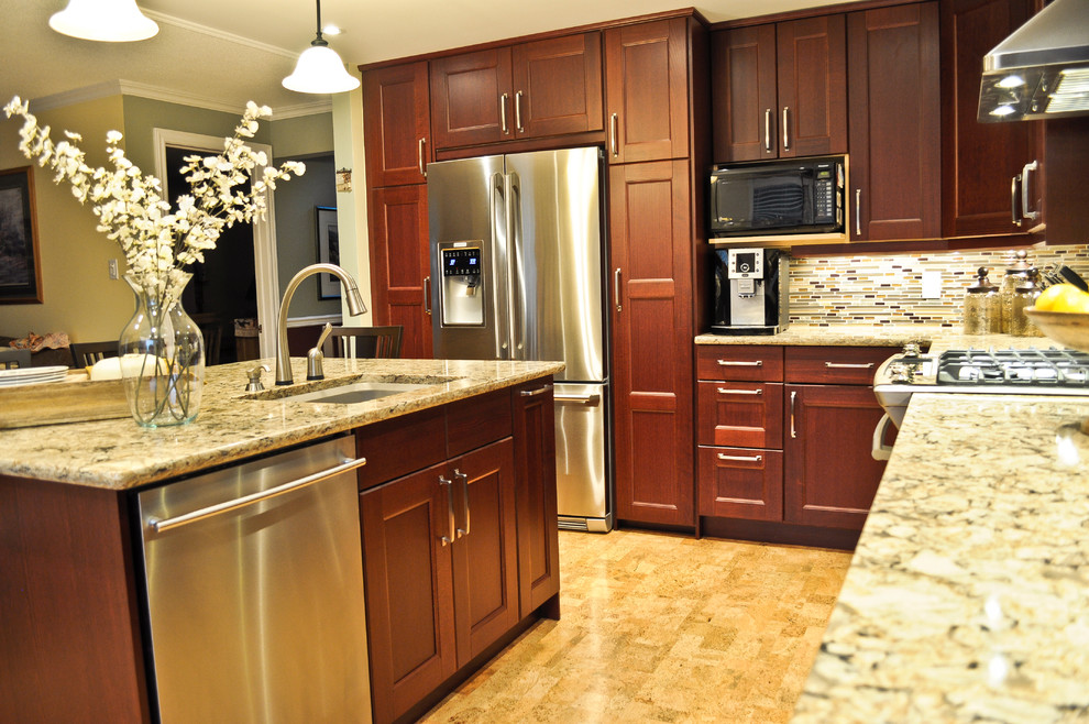 Example of a transitional cork floor kitchen design in Ottawa with recessed-panel cabinets, brown cabinets, quartzite countertops, multicolored backsplash, mosaic tile backsplash, stainless steel appliances and an island