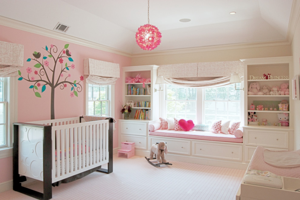 English country home - Sweet nursery with many shades of pinks and cream.  The inspiration for the wall decal came from the client's existing crib.  Pops of hot pink in the pillows, decal and chandelier keep the room fun!