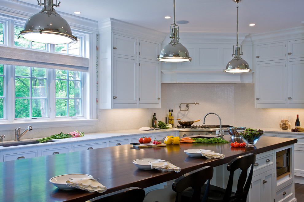 Inspiration for a traditional kitchen in Boston with wood benchtops.
