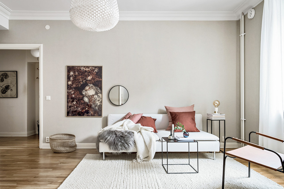 This is an example of a mid-sized scandinavian formal enclosed living room in Gothenburg with grey walls, medium hardwood floors, no fireplace and brown floor.