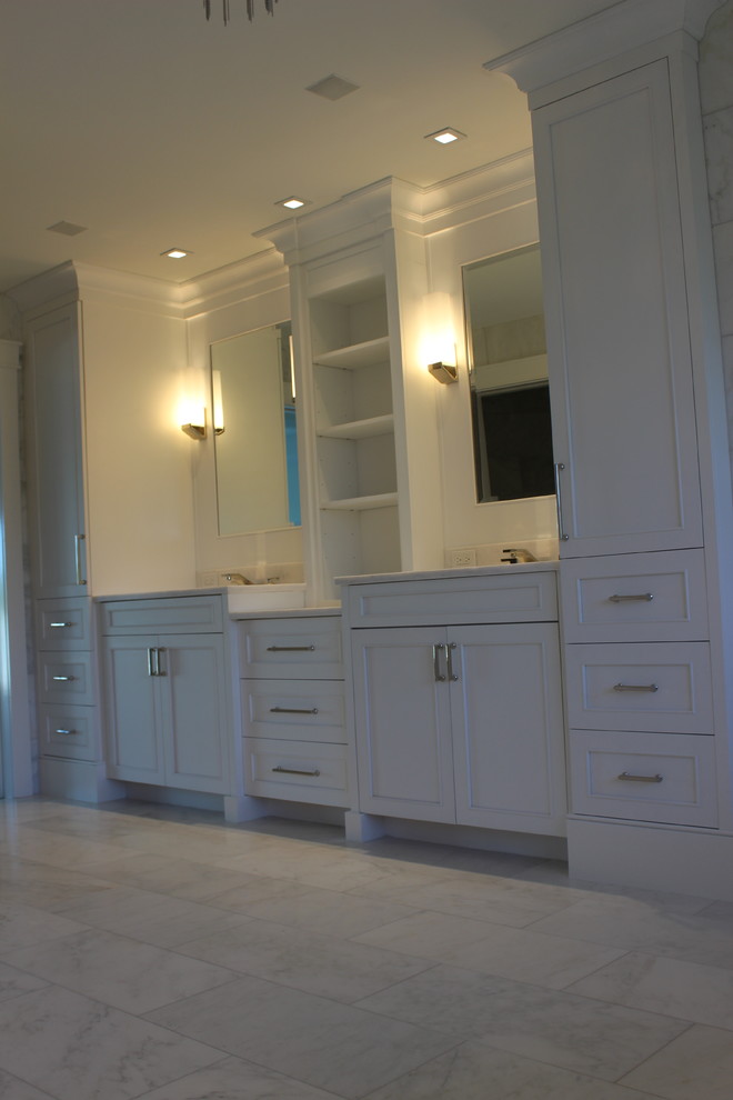 Large transitional master marble floor and white floor doorless shower photo with shaker cabinets, white cabinets, white walls, an undermount sink, marble countertops and white countertops