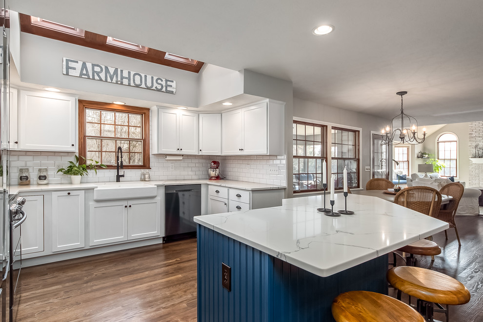 Example of a large transitional u-shaped eat-in kitchen design in Columbus with shaker cabinets, quartz countertops, white backsplash and an island
