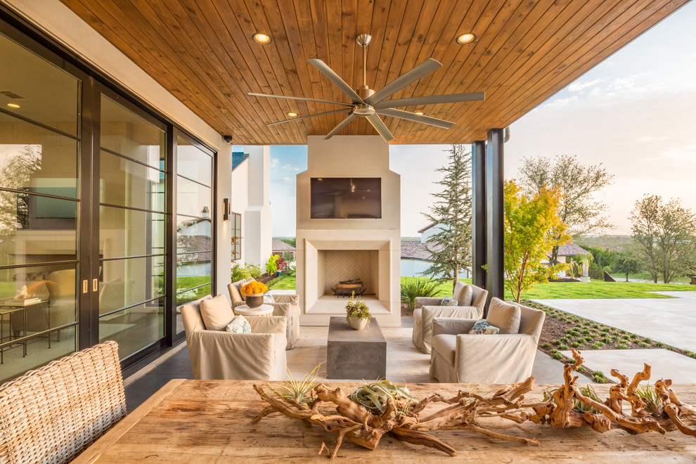 Inspiration for a contemporary patio in Dallas with with fireplace and a roof extension.
