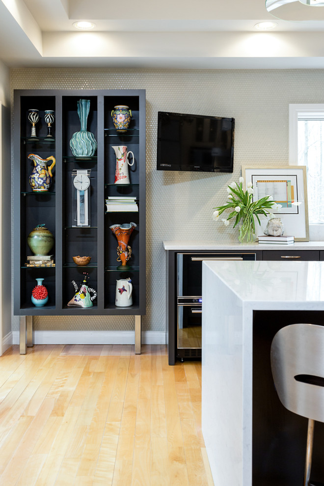 Inspiration for a large transitional l-shaped light wood floor kitchen remodel with flat-panel cabinets, dark wood cabinets, gray backsplash, stainless steel appliances and an island