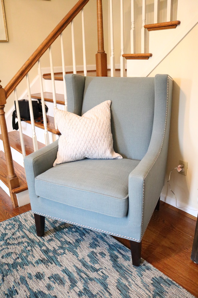 Inspiration for a small transitional medium tone wood floor foyer remodel in Cincinnati with yellow walls