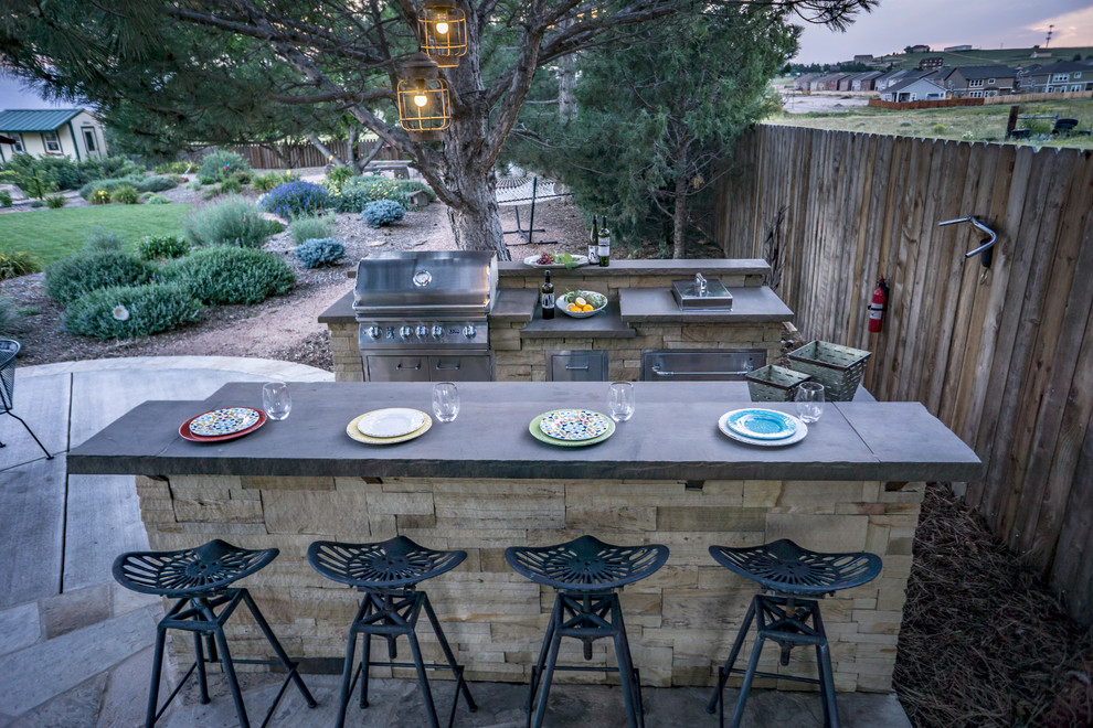 Large cottage backyard stone patio kitchen photo in Denver with no cover