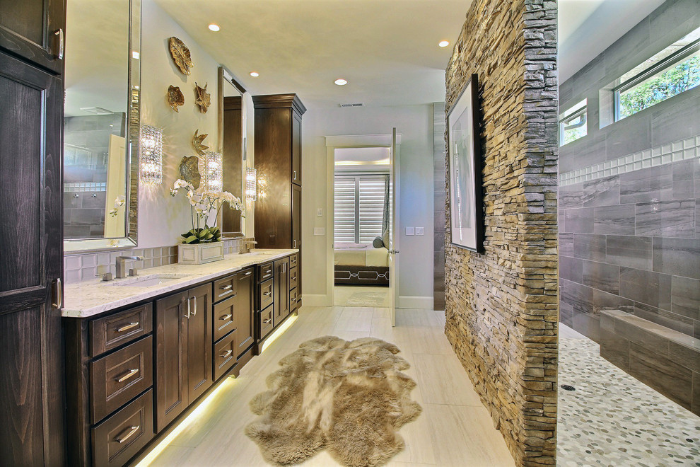 Inspiration for a large transitional master wet room bathroom in Portland with recessed-panel cabinets, dark wood cabinets, a two-piece toilet, gray tile, porcelain tile, beige walls, porcelain floors, an undermount sink, engineered quartz benchtops, grey floor and an open shower.