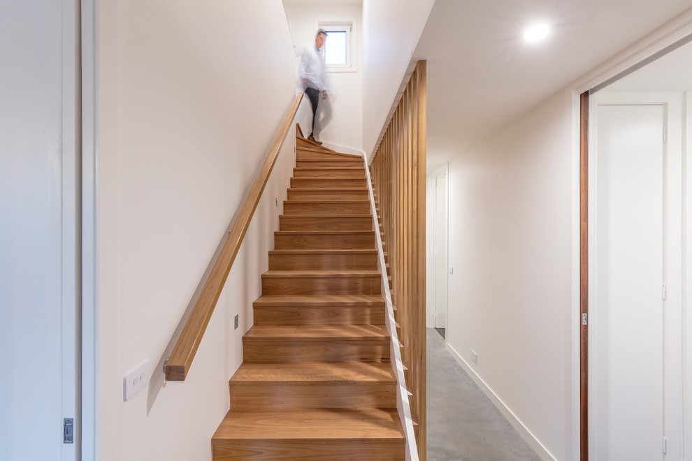 Photo of a mid-sized contemporary wood u-shaped staircase in Canberra - Queanbeyan with wood risers and wood railing.