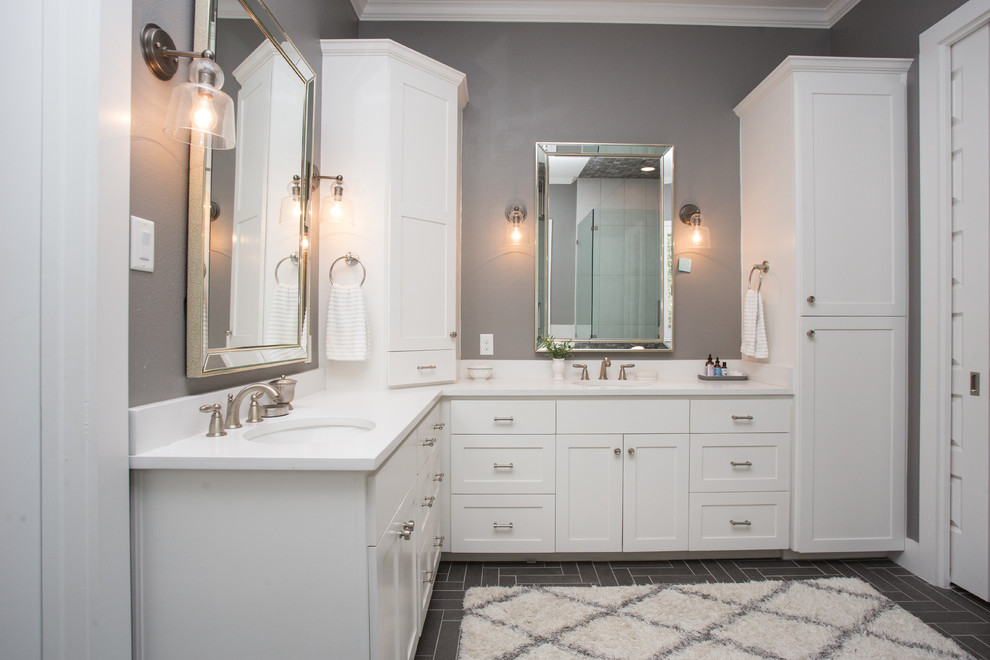 Drop-in bathtub - mid-sized transitional master gray tile and ceramic tile ceramic tile and black floor drop-in bathtub idea in Austin with shaker cabinets, white cabinets, a two-piece toilet, gray walls, an undermount sink, quartz countertops and a hinged shower door