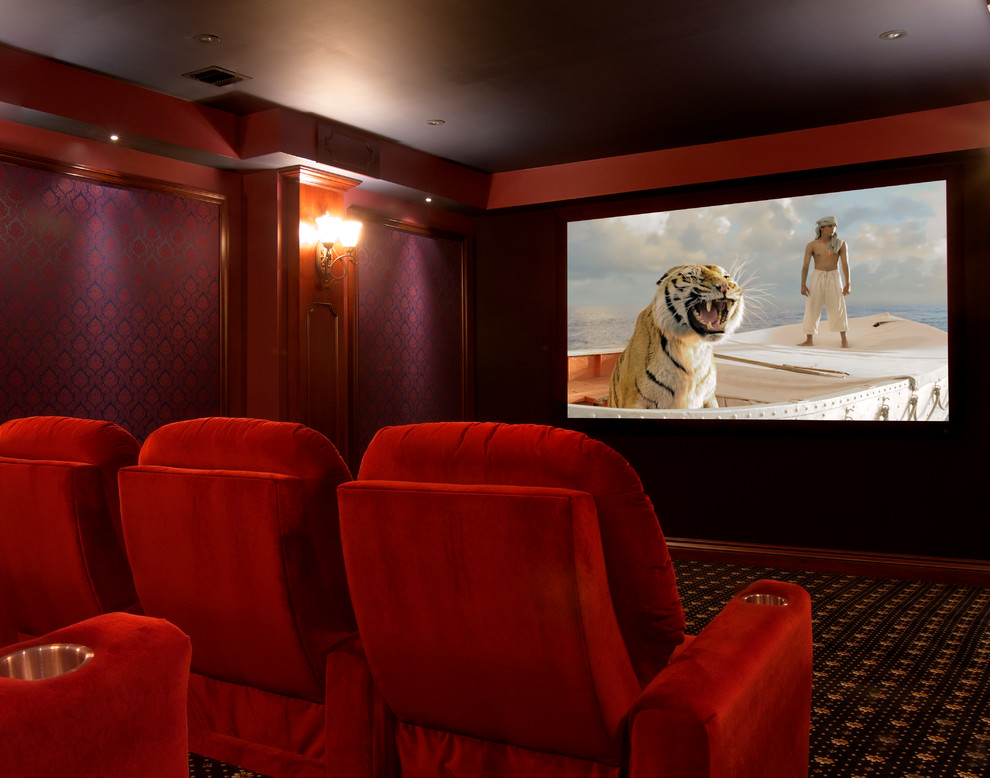 This is an example of a large traditional enclosed home theatre in New York with multi-coloured walls, carpet, a projector screen and brown floor.