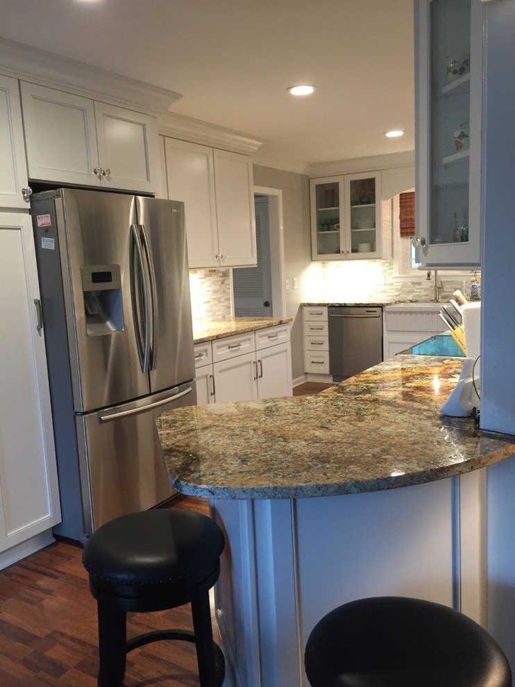 Mid-sized transitional galley separate kitchen in Nashville with a farmhouse sink, flat-panel cabinets, white cabinets, granite benchtops, white splashback, cement tile splashback, stainless steel appliances, dark hardwood floors and no island.