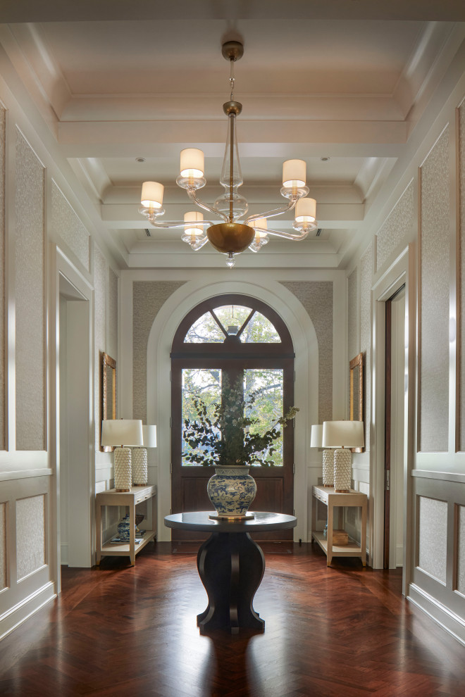 Example of a transitional coffered ceiling foyer design in Denver with a dark wood front door