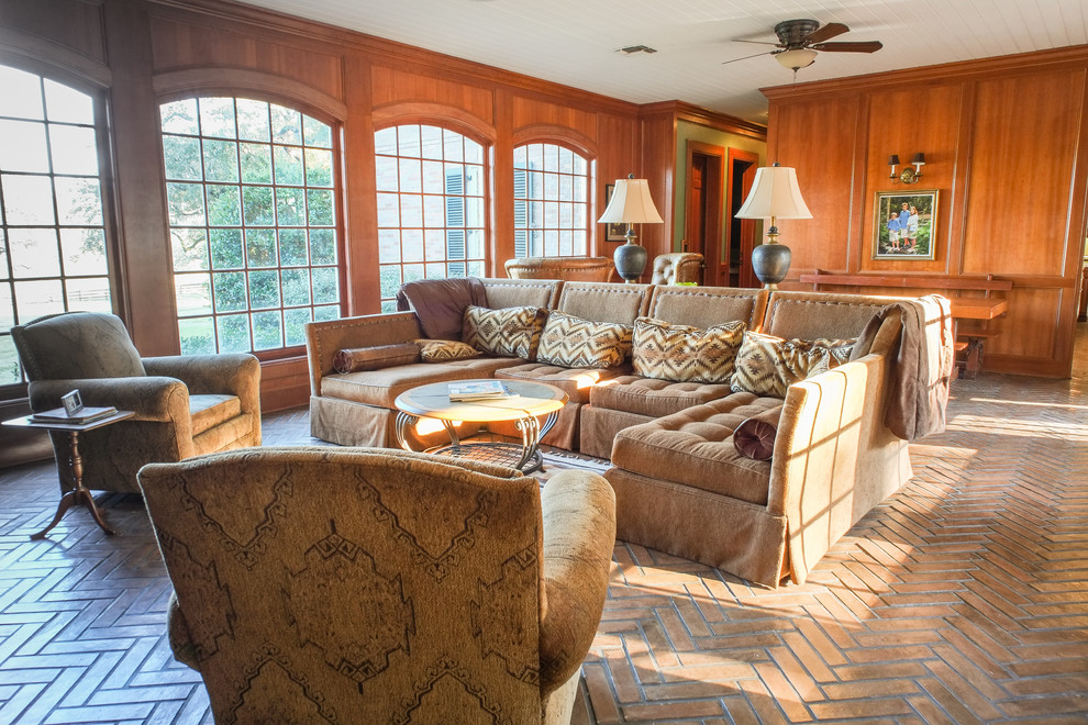 Inspiration for a traditional family room in Austin with brick floors.