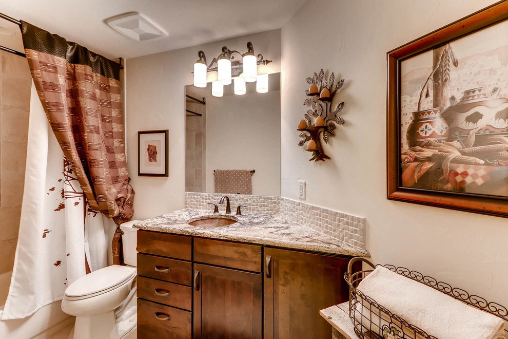 Mid-sized bathroom in Denver with flat-panel cabinets, dark wood cabinets, an alcove tub, a two-piece toilet, white tile, mosaic tile, beige walls, ceramic floors, an undermount sink and granite benchtops.