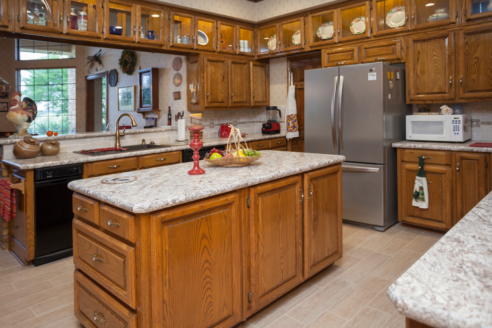 Mid-sized traditional u-shaped separate kitchen in Dallas with raised-panel cabinets, medium wood cabinets, quartz benchtops, beige splashback, ceramic splashback, stainless steel appliances, laminate floors, with island, beige floor and a double-bowl sink.
