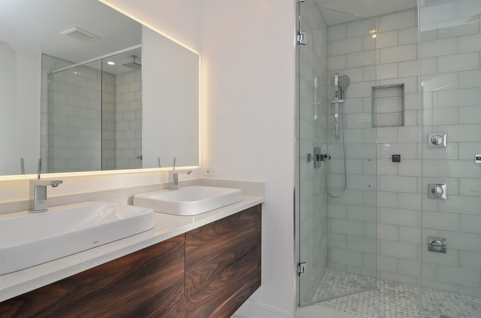 This is an example of a modern bathroom in Chicago with an open shower, ceramic tile, porcelain floors and a hinged shower door.