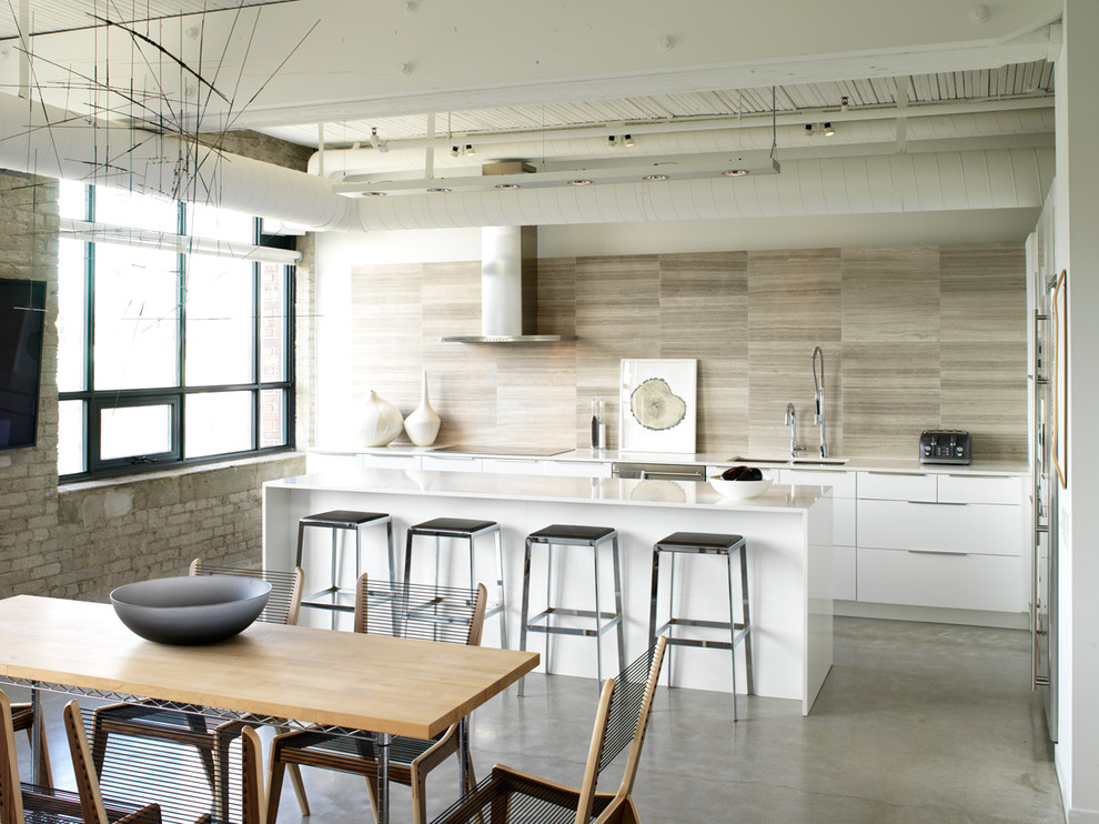 Design ideas for a mid-sized industrial l-shaped eat-in kitchen in Toronto with quartz benchtops, flat-panel cabinets, white cabinets, a double-bowl sink, beige splashback, porcelain splashback, stainless steel appliances, concrete floors, with island and grey floor.