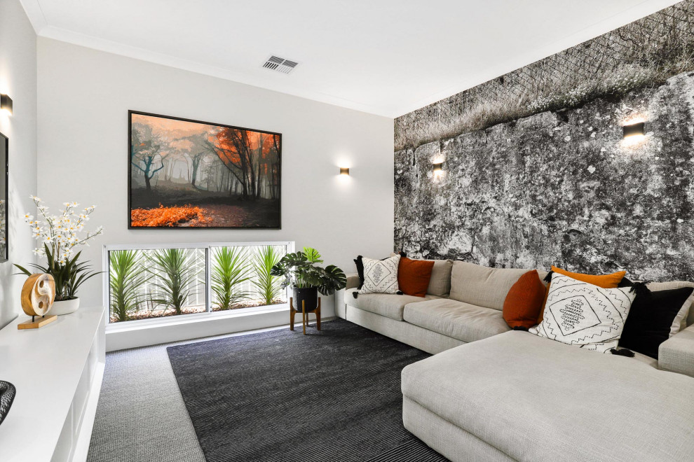 Photo of a mid-sized contemporary enclosed family room in Perth with white walls, carpet, a wall-mounted tv and grey floor.