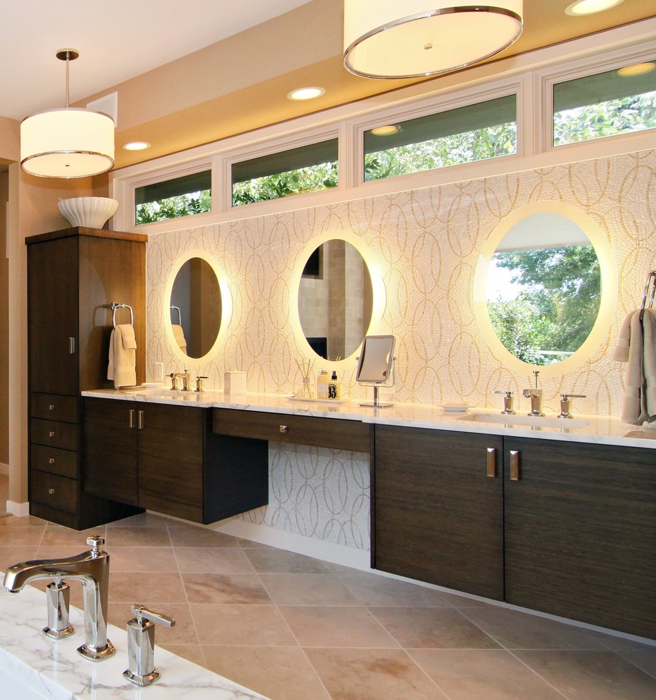 This is an example of a large contemporary master bathroom in Minneapolis with mosaic tile, flat-panel cabinets, dark wood cabinets, beige walls, travertine floors, an integrated sink and marble benchtops.