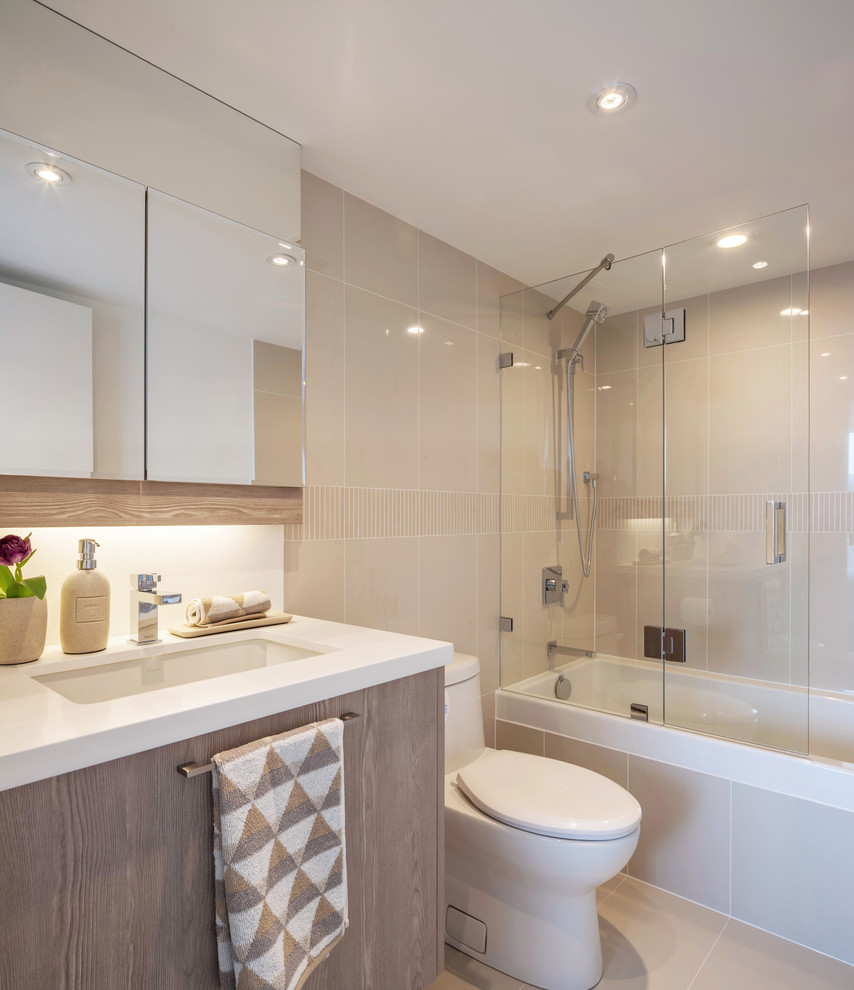 Inspiration for a mid-sized contemporary 3/4 bathroom in Vancouver with light wood cabinets, beige tile, porcelain tile, engineered quartz benchtops, flat-panel cabinets, a drop-in tub, a shower/bathtub combo, a one-piece toilet, beige walls, an undermount sink, porcelain floors and an open shower.