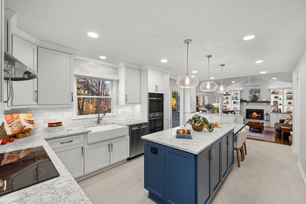 Kitchen - mid-sized transitional kitchen idea in DC Metro with shaker cabinets, white cabinets, quartz countertops, porcelain backsplash, stainless steel appliances and an island