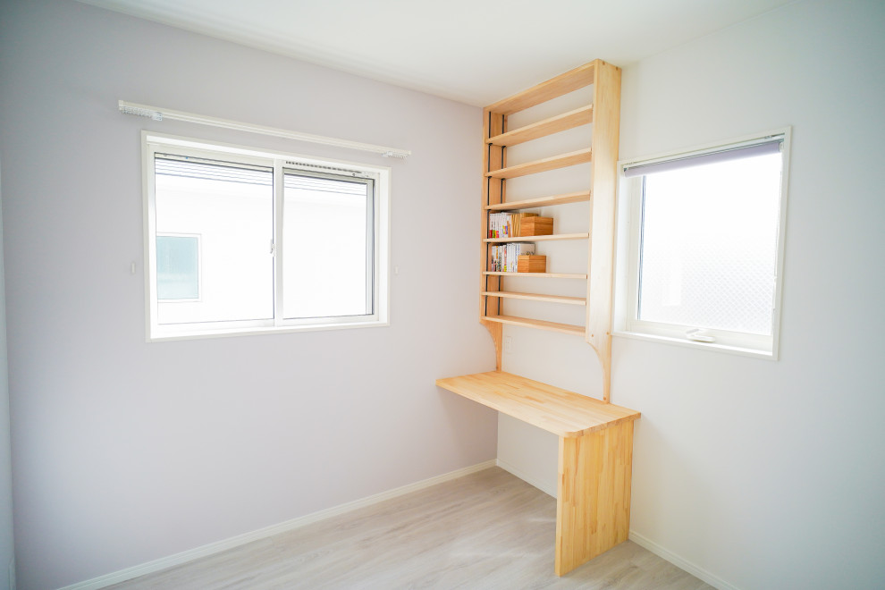 Photo of a mid-sized modern gender-neutral kids' playroom in Other with white walls, plywood floors and white floor.