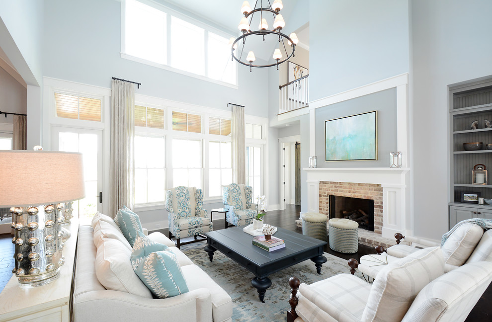 Design ideas for a large transitional open concept living room in Atlanta with grey walls, dark hardwood floors, a standard fireplace, a brick fireplace surround and brown floor.