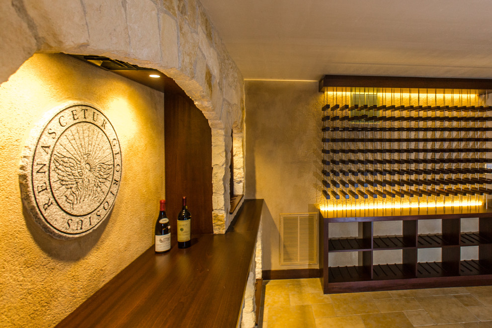 Expansive mediterranean wine cellar in Boston with limestone floors, storage racks and beige floor.