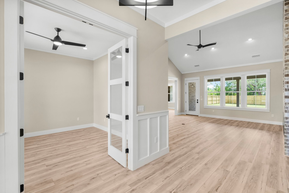 Arts and crafts vinyl floor, beige floor and wainscoting foyer photo with beige walls and a white front door