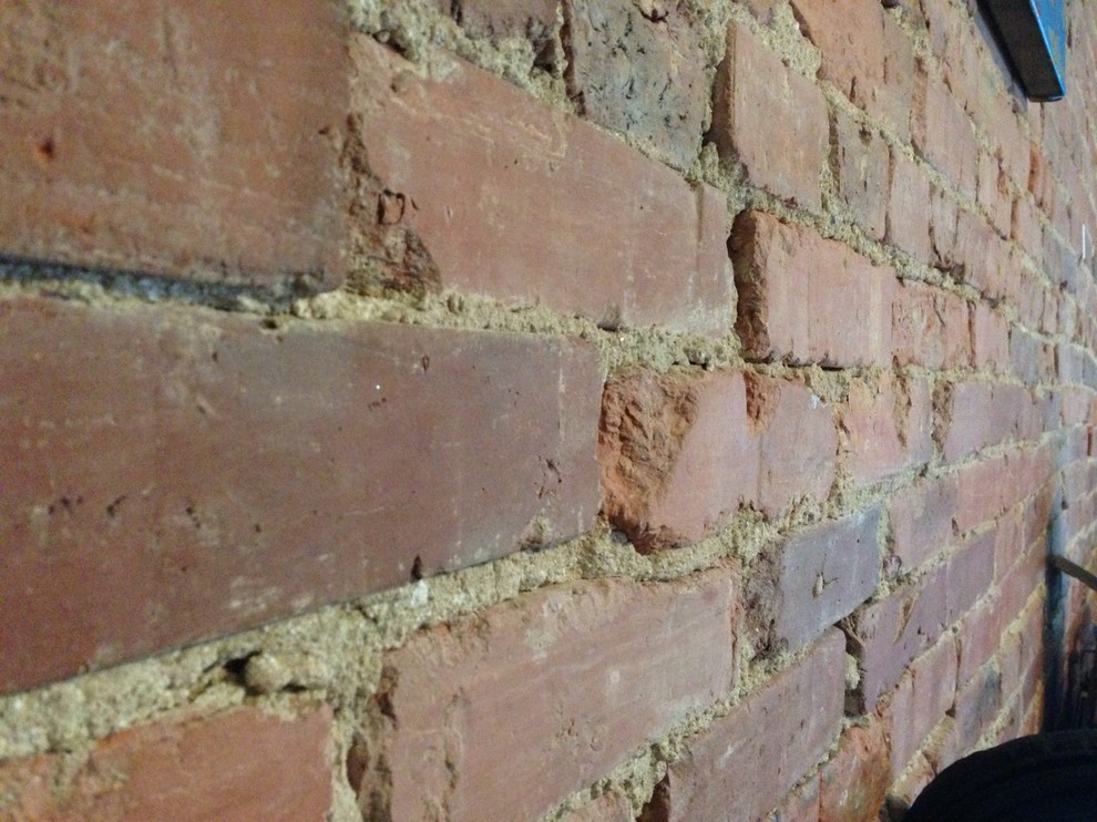 Need help installing a countertop to an uneven brick wall