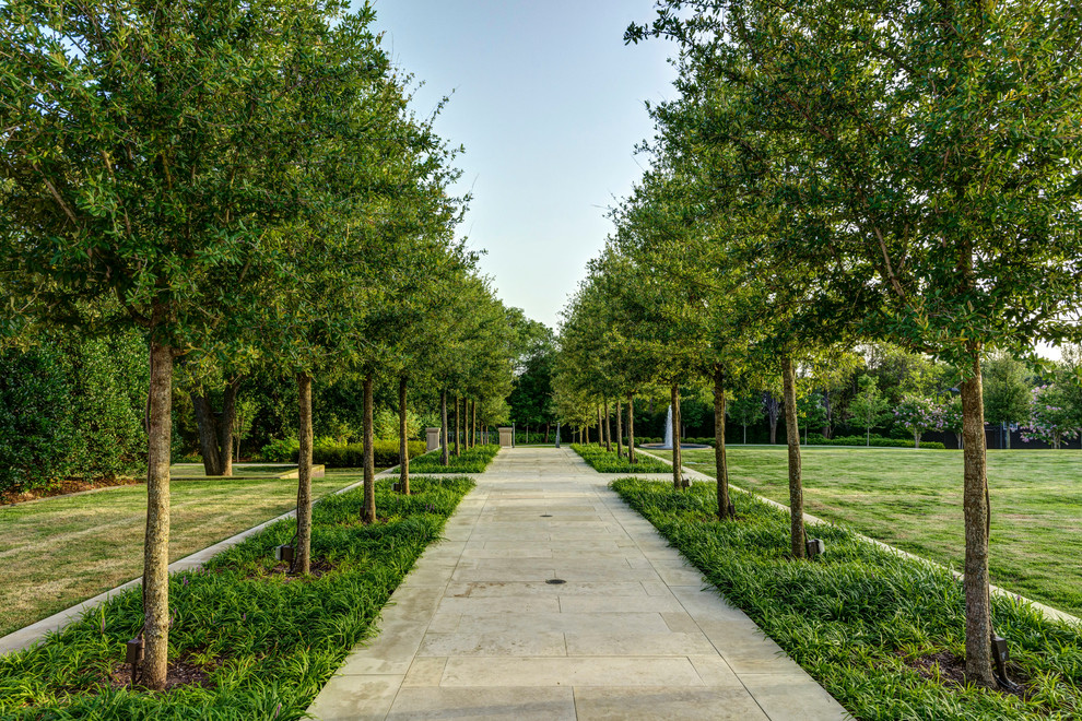 Inspiration for a traditional partial sun garden in Dallas with a garden path.