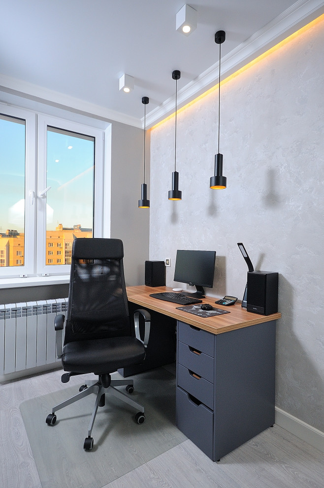 This is an example of a medium sized contemporary study in Moscow with grey walls, light hardwood flooring, a freestanding desk and grey floors.
