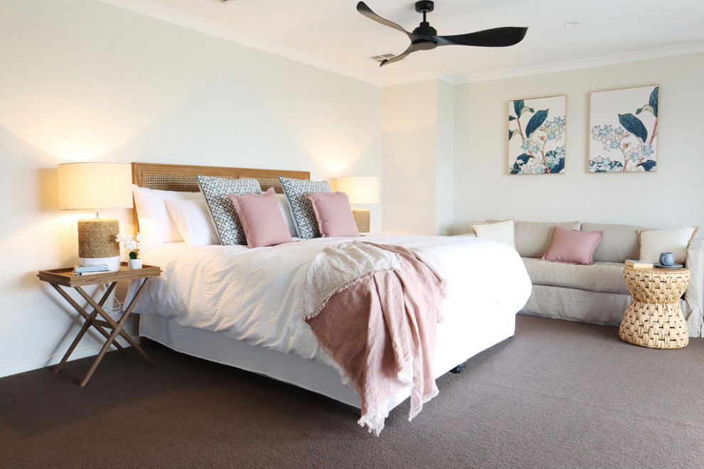This is an example of a mid-sized beach style master bedroom in Other with white walls and carpet.
