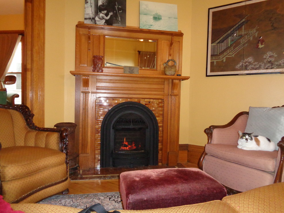This is an example of a small traditional formal enclosed living room in Minneapolis with beige walls, terra-cotta floors, a standard fireplace, a tile fireplace surround and no tv.