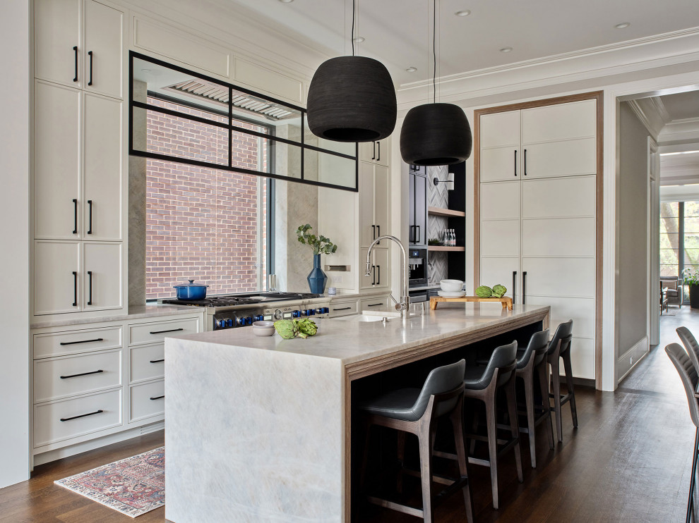 Inspiration for a transitional l-shaped dark wood floor and brown floor eat-in kitchen remodel in Chicago with white cabinets, marble countertops, window backsplash, paneled appliances, an island, gray countertops, a farmhouse sink and shaker cabinets