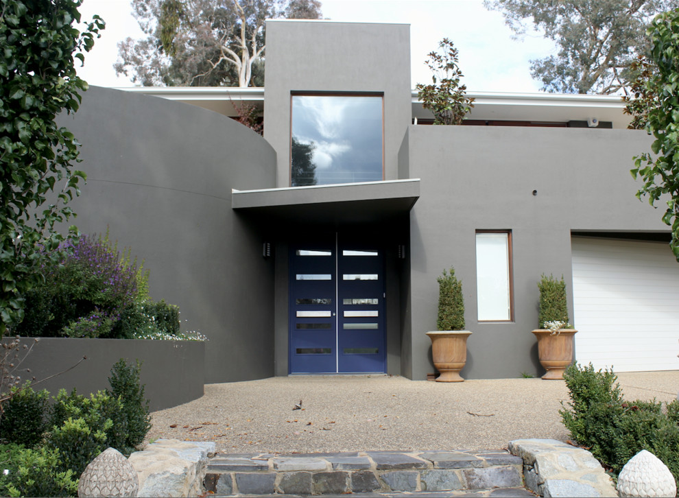 Large transitional two-storey brick brown house exterior in Canberra - Queanbeyan with a hip roof and a metal roof.