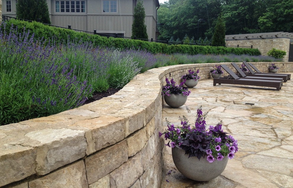 Traditional garden in Columbus with a retaining wall.