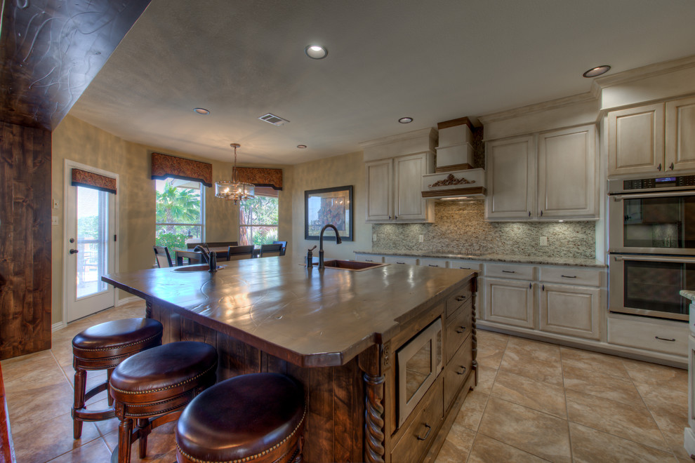 Eat-in kitchen - mid-sized rustic l-shaped eat-in kitchen idea in Austin with a single-bowl sink, wood countertops, stainless steel appliances and an island