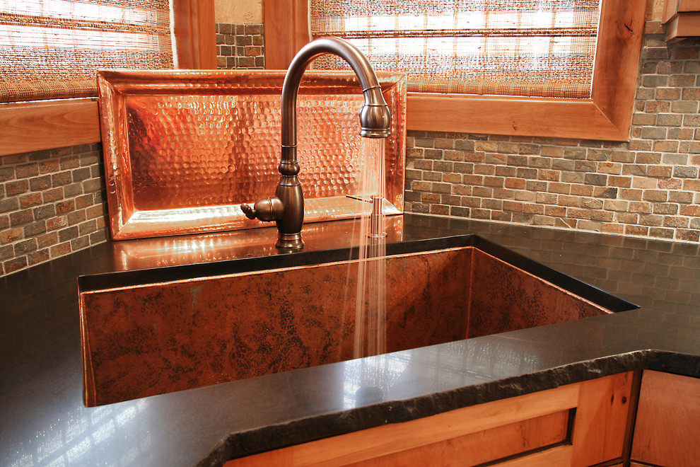 Large mountain style u-shaped medium tone wood floor eat-in kitchen photo in Seattle with an undermount sink, shaker cabinets, medium tone wood cabinets, solid surface countertops, multicolored backsplash, mosaic tile backsplash, stainless steel appliances and two islands