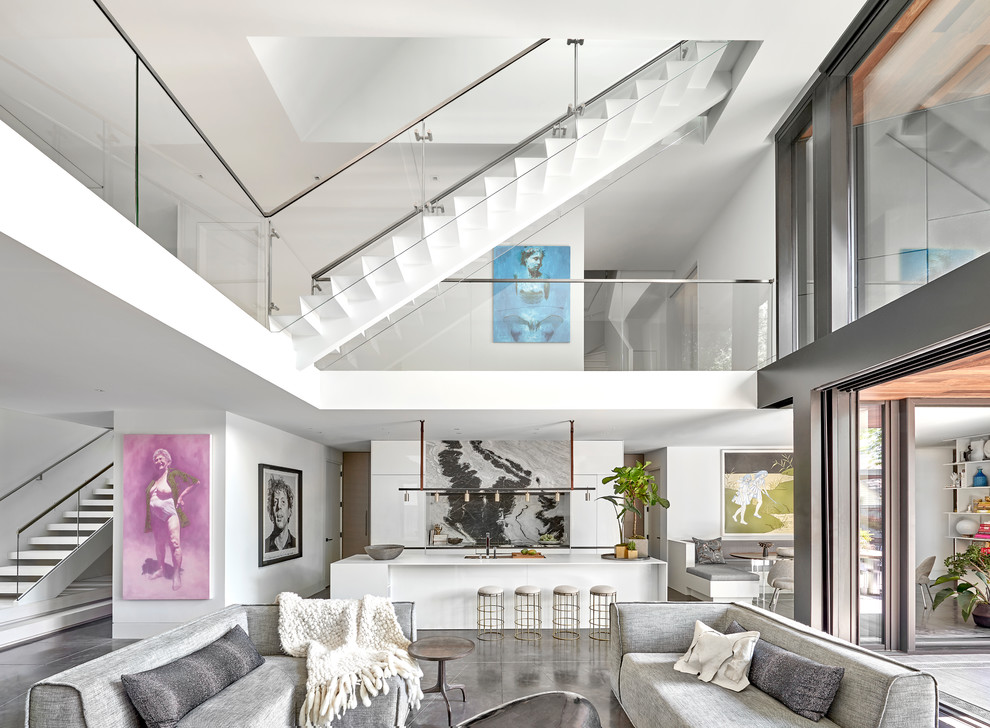 Large contemporary open concept living room in Chicago with white walls, concrete floors, a hanging fireplace, a wood fireplace surround, a concealed tv and grey floor.