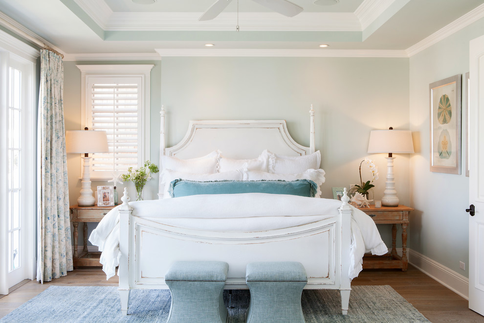 Mid-sized beach style master bedroom in Orange County with medium hardwood floors and green walls.