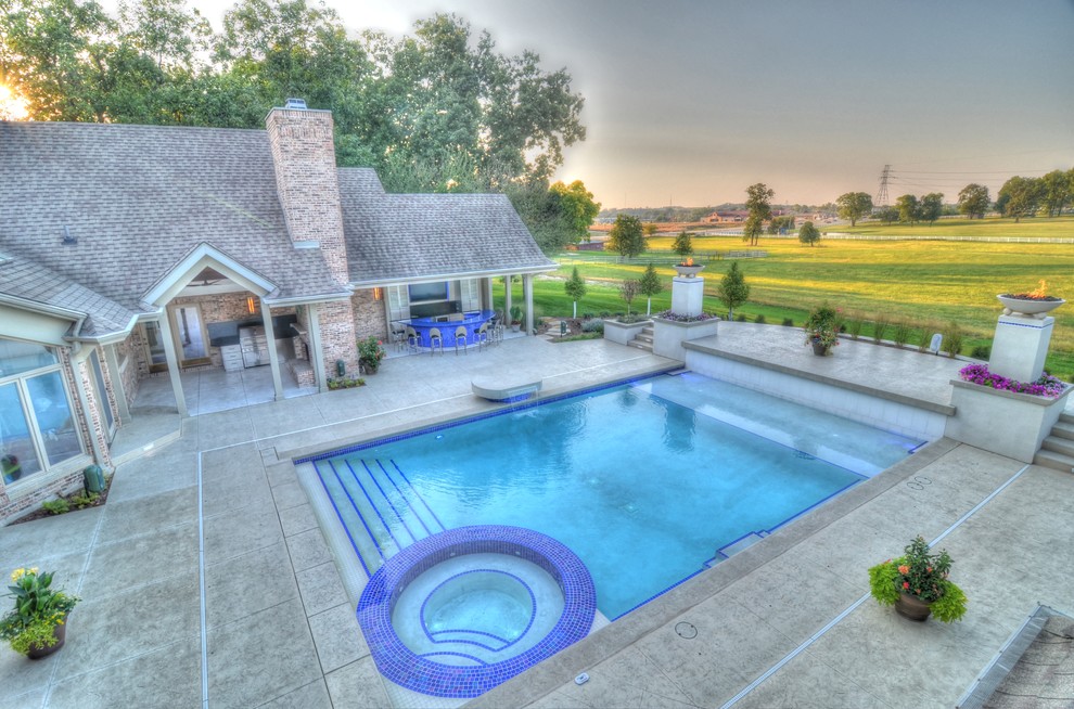 Large transitional backyard concrete paver and rectangular natural hot tub photo in Cedar Rapids