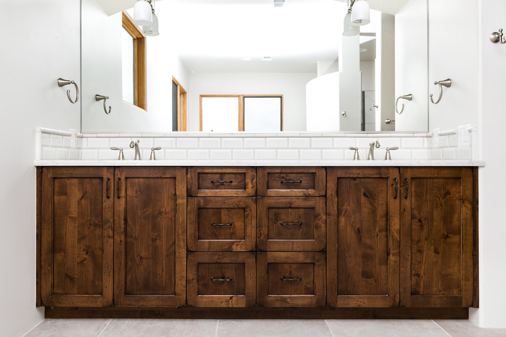 Example of a mid-sized mountain style master white tile and subway tile ceramic tile walk-in shower design in Albuquerque with an undermount sink, quartz countertops, white walls, shaker cabinets and dark wood cabinets